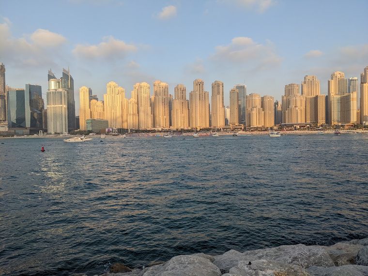 The JBR skyline across the water at sunset in Dubai