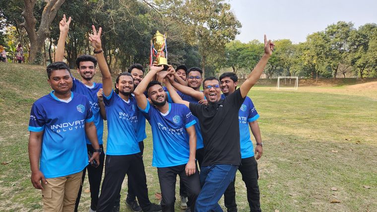 Innovate Solution team celebrating with a trophy at the company picnic