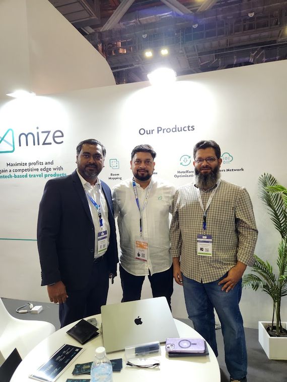 Three people at an exhibitor stand at Travel Tech Asia 2025